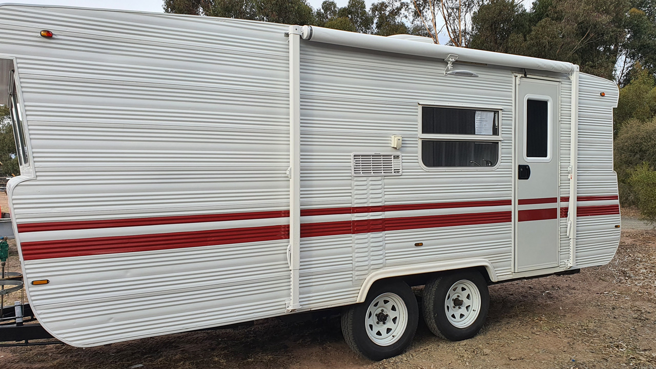 Caravan with its new red stripes and awning installed